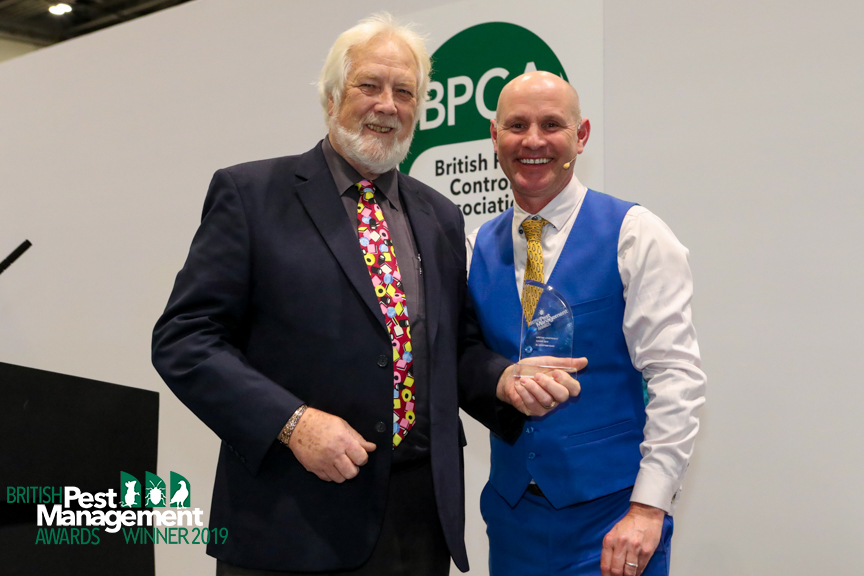 Dr Wade getting his award from television ecologist, Mike Dilger